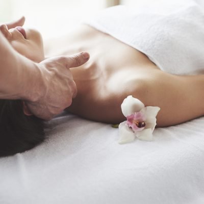 Close-up of a young woman gets a massage at the beauty salon. Procedures for skin and body